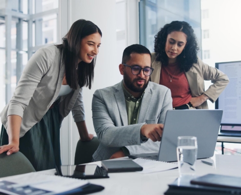 tech professional helping business workers with their laptop