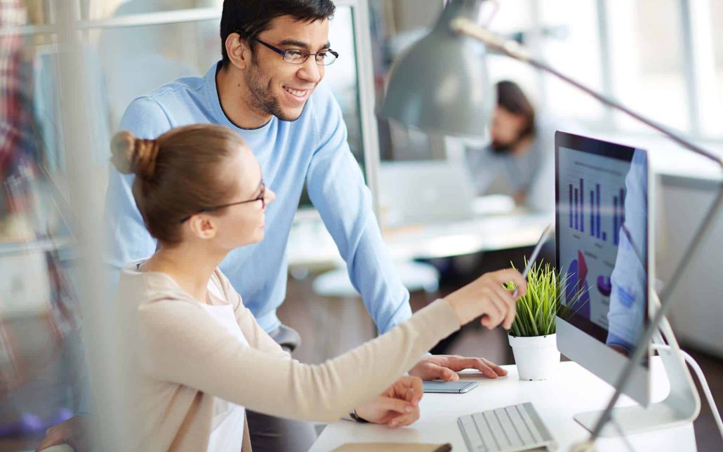 Coworkers-Looking-at-Analytical-Data-on-Monitor